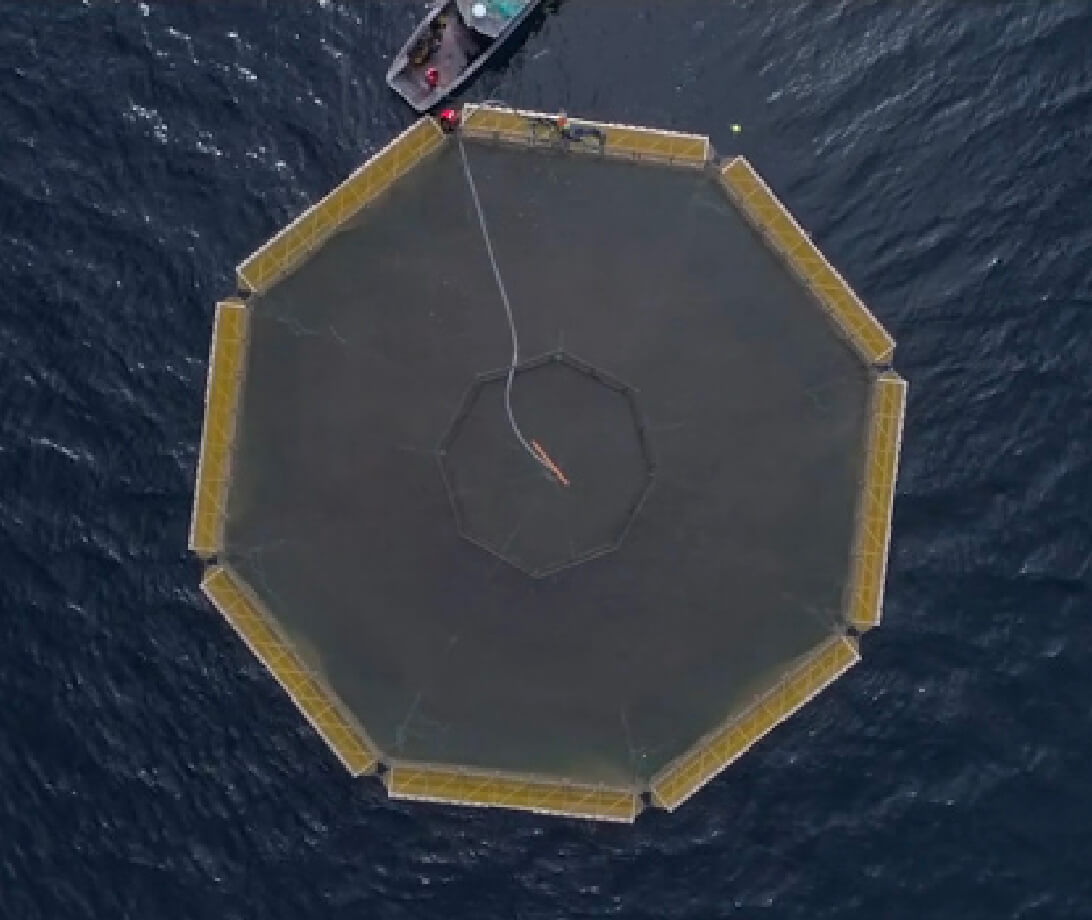 Aerial view of an open ocean pen