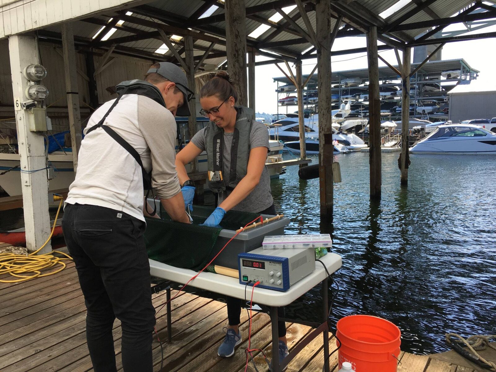 Two scientists with fish tracking equipment