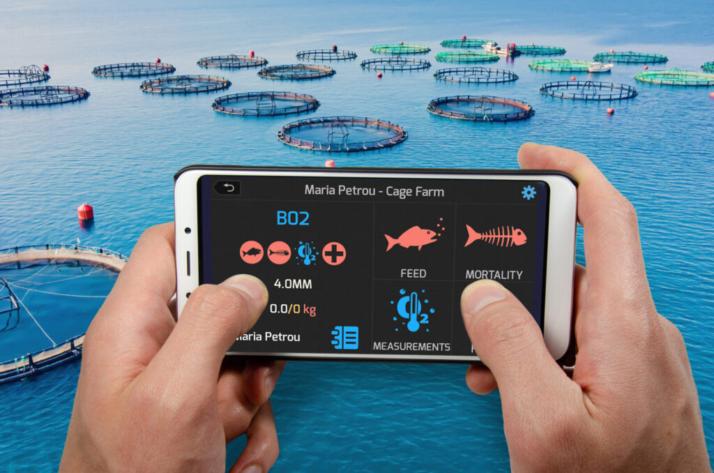 Hands holding smartphone displaying aquaculture management app over fish farm with circular sea cages in blue water.