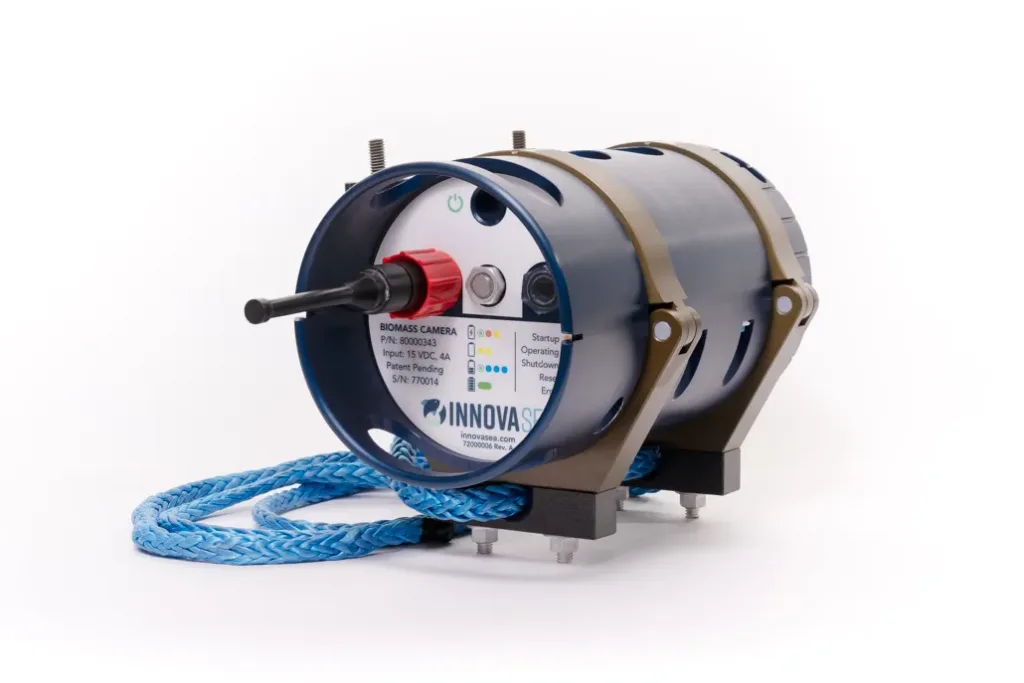 Innovasea biomass pro camera device with cylindrical housing, control panel with LED indicators, and blue braided cable attachment.