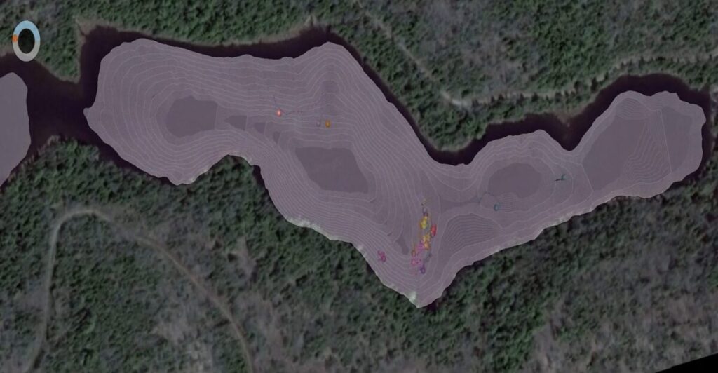 Aerial satellite view of a lake with topographic contour lines overlaid, showing depth measurements and scattered colored markers on the water surface for fish positioning.